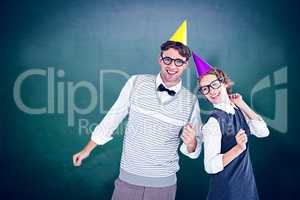 Composite image of geeky hipster couple wearing a party hat