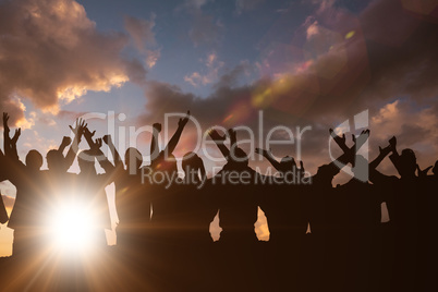 Composite image of silhouetters celebrating Composite image of silhouetters celebrating