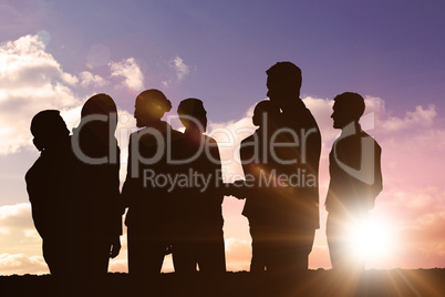 Composite image of silhouetters celebrating