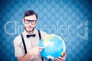 Composite image of geeky hipster holding a globe