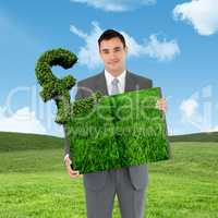 Composite image of man holding lawn book