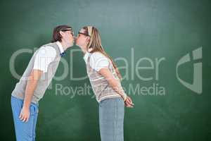 Composite image of geeky hipster couple kissing