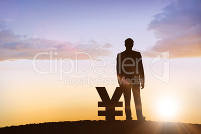 Composite image of silhouette beside yen symbol