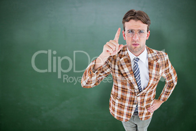 Composite image of upset geeky hipster pointing at camera