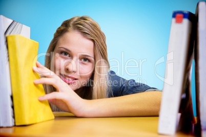 Composite image of pretty student in the library