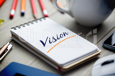 Vision  against notepad on desk