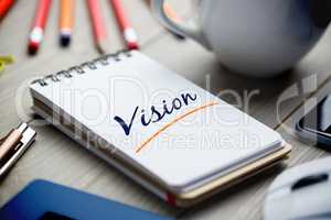 Vision  against notepad on desk