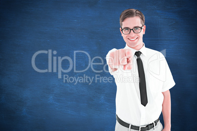 Composite image of geeky young hipster pointing at camera