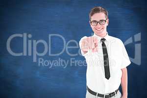 Composite image of geeky young hipster pointing at camera