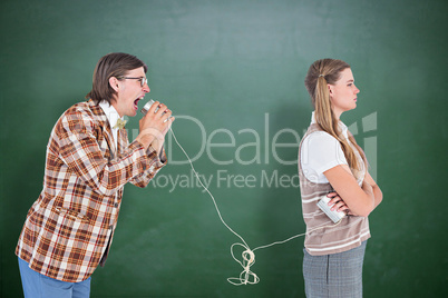 Composite image of geeky hipsters using string phone