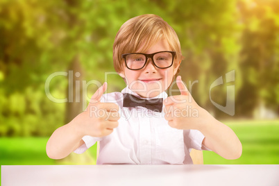 Composite image of cute pupil showing thumbs up