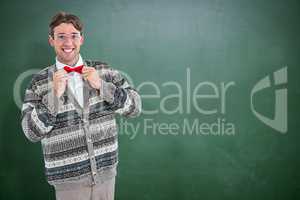 Composite image of happy geeky hipster with wool jacket