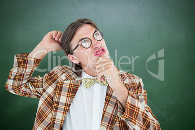 Composite image of geeky hipster scratching his head