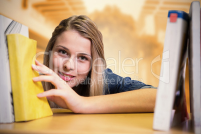 Composite image of pretty student in the library