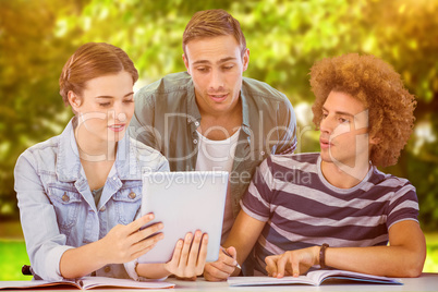 Composite image of fashion students using tablet