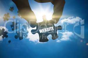 Website against bright blue sky with clouds