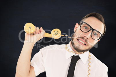 Composite image of geeky businessman being strangled by phone cord