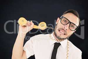 Composite image of geeky businessman being strangled by phone cord