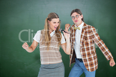 Composite image of happy geeky hipsters singing with microphone