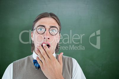 Composite image of geeky hipster looking surprised at camera