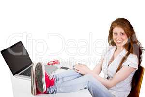 Composite image of pretty redhead with feet up on desk