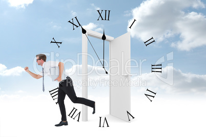 Composite image of geeky businessman running late