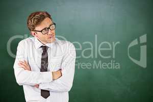 Composite image of young businessman thinking with arms crossed