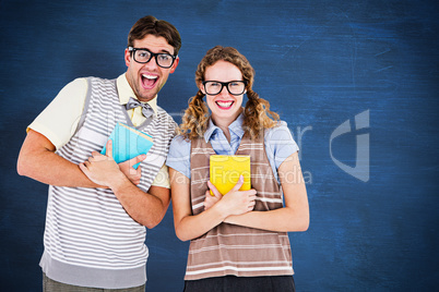 Composite image of geeky hipster couple holding books and smilin