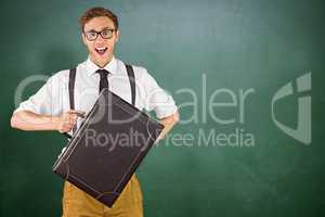 Composite image of geeky businessman holding his briefcase