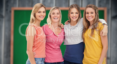 Composite image of four friends standing beside each other and s