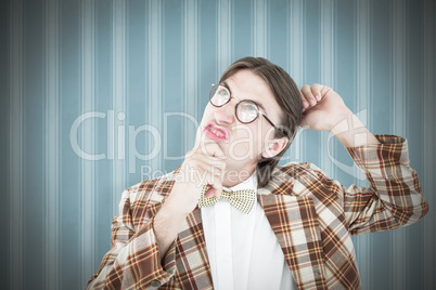 Composite image of geeky hipster scratching his head