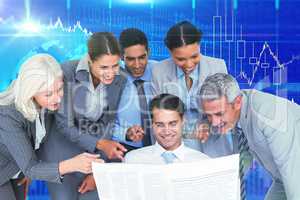 Composite image of happy business people looking at newspaper