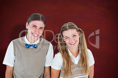 Composite image of smiling geeky hipsters looking at camera