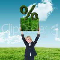 Composite image of woman holding up lawn book