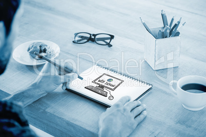 Composite image of creative businessman writing notes on noteboo Composite image of creative businessman writing notes on noteboo