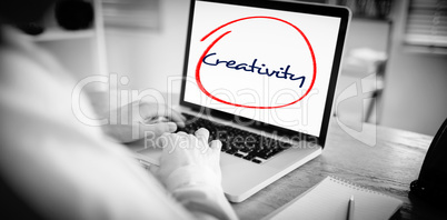 Creativity  against businessman working on his laptop