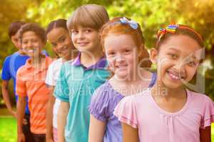 Composite image of smiling pupils in classroom