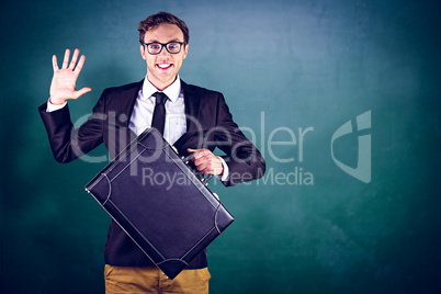 Composite image of young geeky businessman holding briefcase