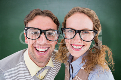 Composite image of happy geeky hipster smiling at camera Composite image of happy geeky hipster smiling at camera