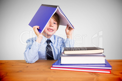 Composite image of cute pupil with books