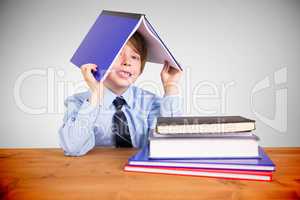 Composite image of cute pupil with books