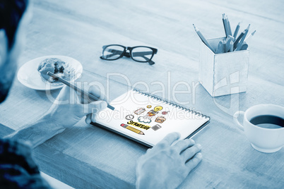 Composite image of creative businessman writing notes on noteboo