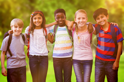 Composite image of smiling little school kids in school corridor