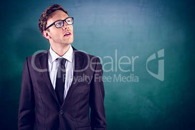 Composite image of young businessman thinking and looking up