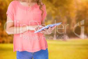 Composite image of hipster woman holding tablet pc