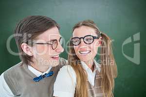 Composite image of geeky hipster couple smiling at each other