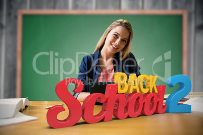 Composite image of student studying in the library with tablet