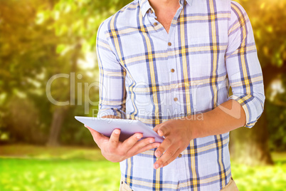 Composite image of young student using tablet pc