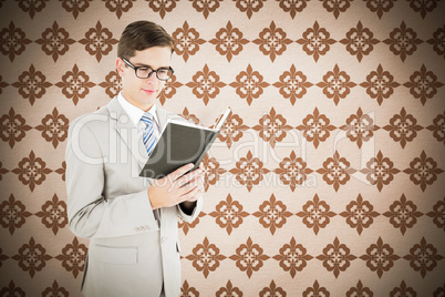 Composite image of geeky businessman reading black book