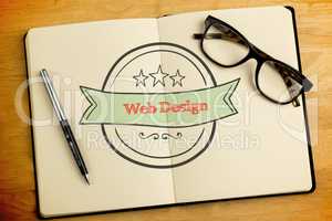 Web design against overhead of open notebook with pen and glasse